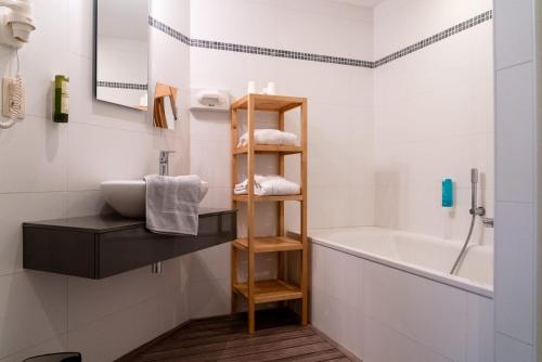 a bathroom with a sink and a bath tub at Moulin de Daverdisse in Daverdisse