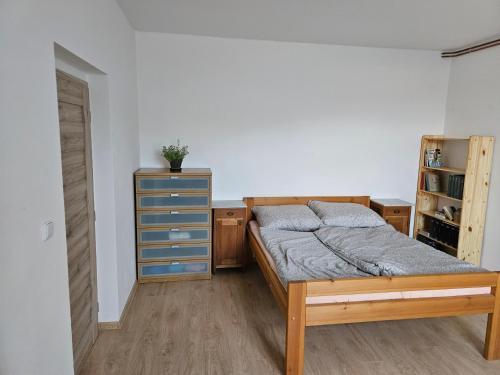 a bedroom with a bed and a dresser at Apartment Nová Ves 26 in Olešník