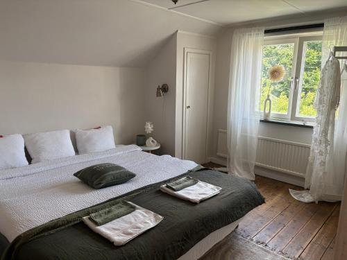 a bedroom with a bed with two towels on it at Glemminge Bed & Bastu in Glemminge