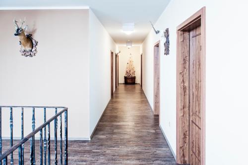 a hallway of a home with white walls and wood floors at Hospůdka na Haldě in Boršice