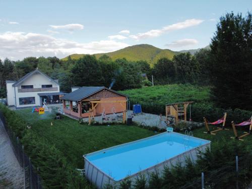 a large backyard with a pool and a house at Cabana 1407 Valea Avrigului in Avrig