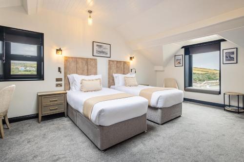 a hotel room with two beds and a window at Falcon's Nest Hotel in Port Erin