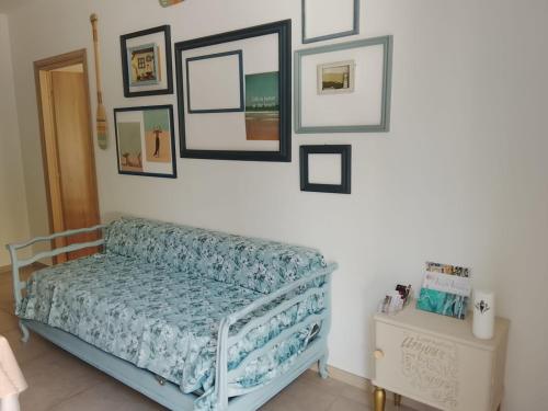 a bedroom with a bed and pictures on the wall at Le stanze di veneranda in Silvi Marina