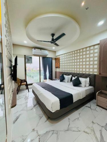a bedroom with a large bed in a room at Hotel Yagnik Inn in Rajkot