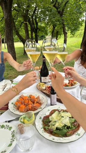 a group of people sitting at a table with wine glasses at Biondelli Boutique Winery in Cazzago San Martino