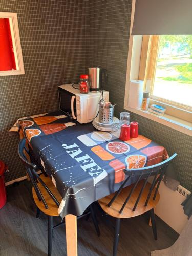 a table in a kitchen with a coffee maker on it at Vierashuone 1 
