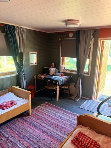 a room with a bed and a desk with a table at Vierashuone 1 