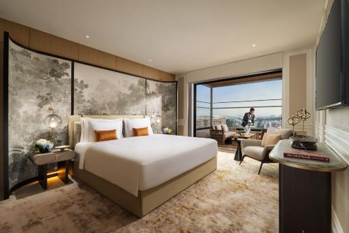 a bedroom with a large bed and a large window at Taj Palace, Lucknow in Lucknow