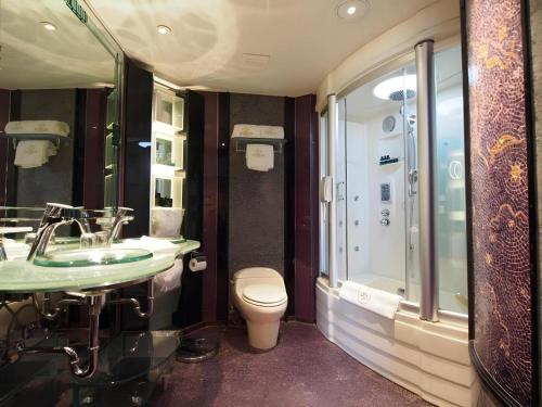 a bathroom with a toilet and a sink and a shower at Hotel Lisboa in Macau
