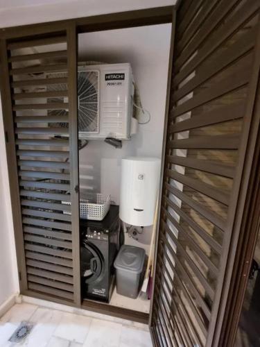 a room with a computer and a air conditioner at Blue water house in Tamaris