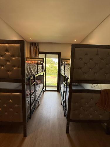 a room with three bunk beds and a doorway at Blue water house in Tamaris