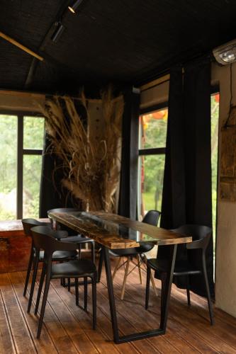 a dining room with a glass table and chairs at Netri SPA in Zofʼyuvka