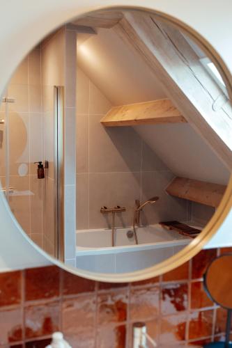 a bathroom with a shower and a mirror at Granny's B&B in Kapelle