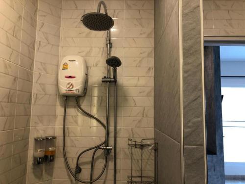a shower with a shower head in a bathroom at CoCo Tree Resort in Thap Sakae