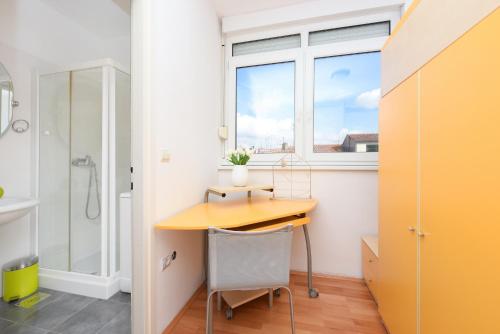 a desk in a bathroom with a window at Jelena - Spacious Sea View Apartment - Old Town Zadar in Zadar
