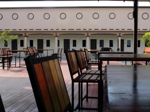 a group of tables and chairs on a patio at Surintara Resort in Surin