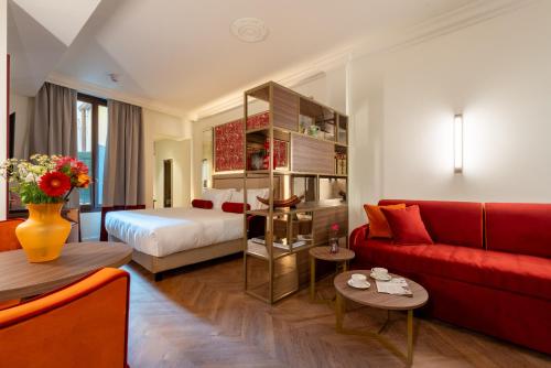 a hotel room with a bed and a red couch at Hotel San Samuele in Venice