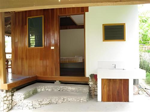 a bathroom in a house with a sink at Mayas Native Garden Resort in Basdiot