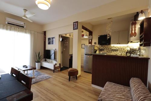 a kitchen and a living room with a table at Shalom in Colva