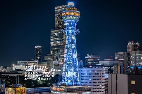 a lit up tower in a city at night at ESLEAD HOTEL Namba South Ⅲ in Osaka