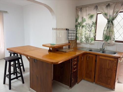 a kitchen with a wooden counter and a sink at 2 bedrooms Ngubelanga Stays in Margate