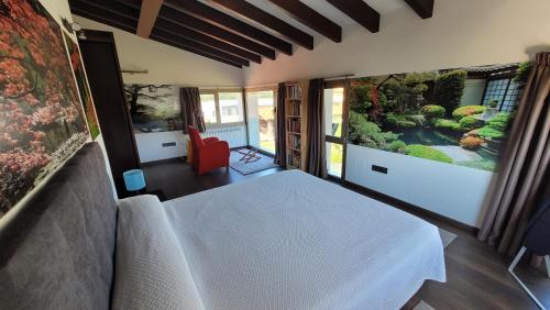 a room with a white bed and an aquarium at Hotel Jardín de Aura in Muros de Nalón