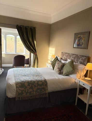 a hotel room with a bed and a window at The Monsal in Monsaldale Station