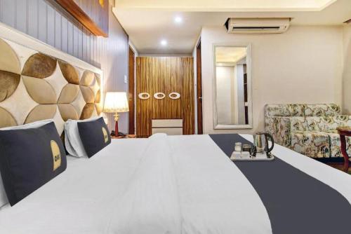 a hotel room with a large bed and a couch at Saffron by Stay Pattern - City Center in Srinagar