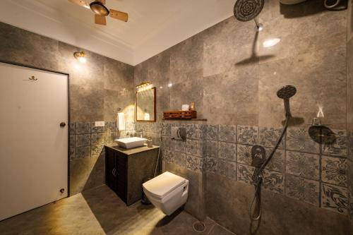 a bathroom with a toilet and a sink at The Elegant homes in Kushālnagar