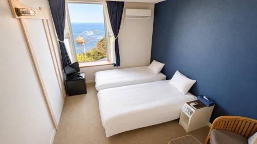 Una cama o camas en una habitación de Hotel Cliffside