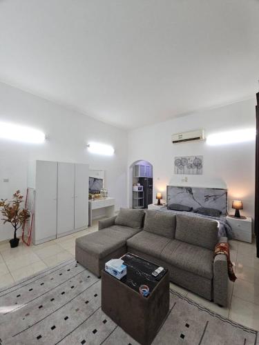 a living room with a couch and a table at Towaya studio in Al Ain