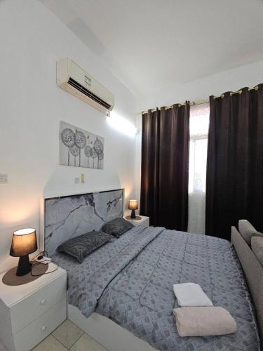 a bedroom with a large bed and a window at Towaya studio in Al Ain