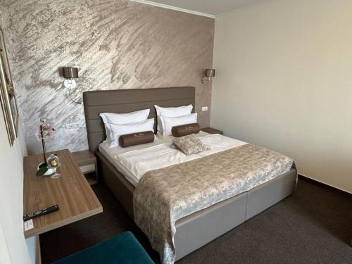 a bedroom with a large bed and a table at B&B Vila Milčetić in Malinska