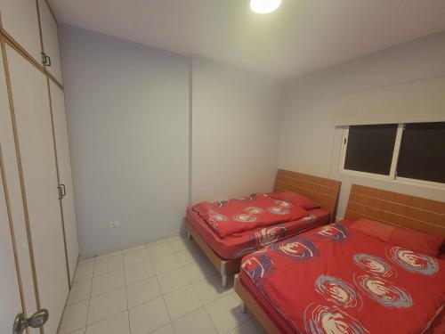 a small room with two beds and a window at Chalet 1BR 1BA with Beach&Pool&Tennis&Basketball in Jounieh