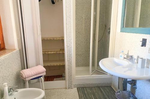 a bathroom with a shower and two sinks and a shower at Guesthouse Nuvole in Olbia