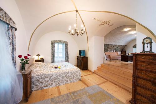 a bedroom with an archway and a bed in a room at Chateau GrandCastle in Liptovský Hrádok