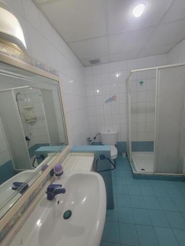 a bathroom with a sink and a mirror and a shower at Chalet 1BR 1BA with Beach&Pool&Tennis&Basketball in Jounieh