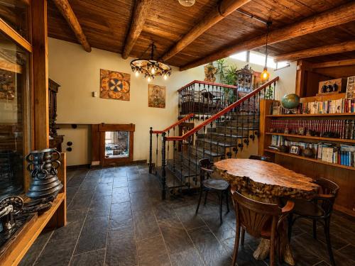 a dining room with a table and a spiral staircase at Casa de Aira Padron 