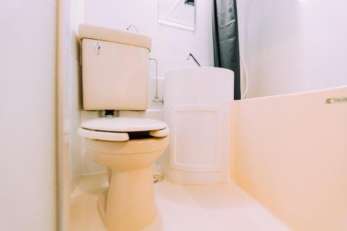 a white bathroom with a toilet and a sink at Work Ready Stay - Quiet Nakasu 202 in Fukuoka