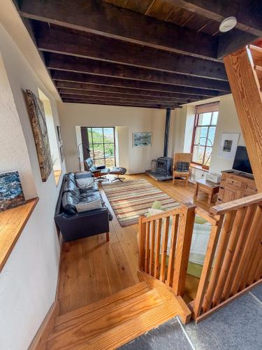 a large living room with a couch and wooden floors at The Mill O Cara in Orkney