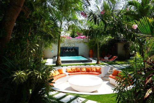 a garden with a couch and a fire place at Lukas Garden Accra Exclusive Resort in Accra