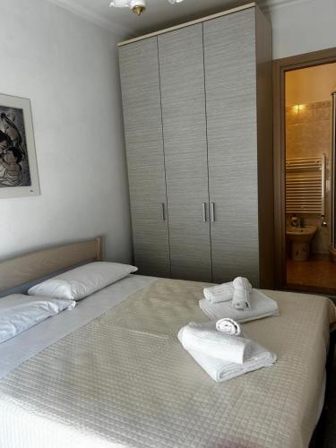 a bedroom with two towels sitting on a bed at B&b La Casa di Michela in Castelmezzano