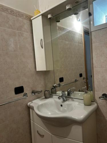 a bathroom with a sink and a mirror at B&b La Casa di Michela in Castelmezzano