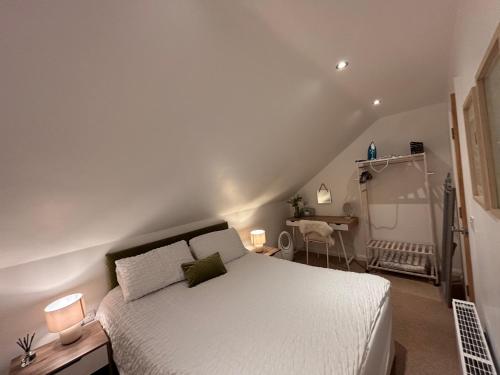 a bedroom with a white bed and a desk at Room with a View in Aldergrove