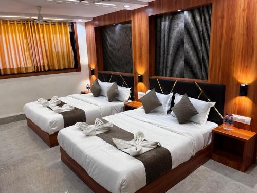 a hotel room with two beds with bows on them at Hotel Avion Park Executive in Mumbai