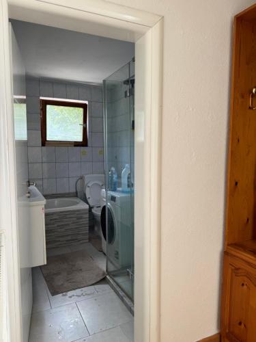 a bathroom with a tub and a toilet and a sink at XXL apartman Free parking in Visoko