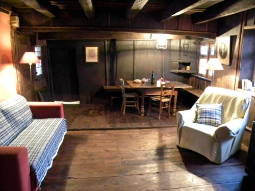 a living room with a table and a couch at La Ferme de Marie in Rangen