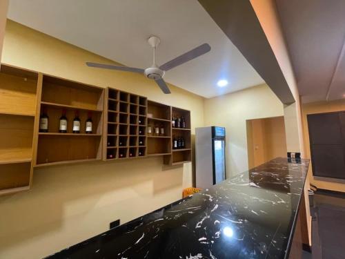 a kitchen with a counter top and a ceiling fan at Anaviosi Villa in Anum