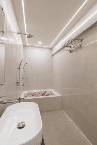 a bathroom with a toilet and a shower and a sink at Lake Bloom Residency in Mumbai