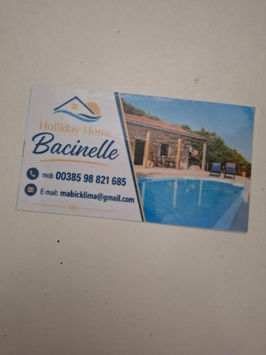 a sign for a house with a swimming pool at BACINELLA apartmani in Baćina